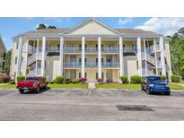 Spacious condo complex featuring multiple units, covered balconies, and well-maintained landscaping at 5846 Longwood Dr. # 302, Murrells Inlet, SC 29576