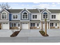 Charming townhomes featuring attached garages, well-manicured landscaping, and a modern architectural design at 904 62Nd Ave. N # E, Myrtle Beach, SC 29572