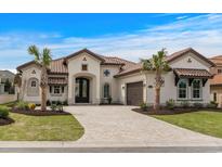 Stunning home features a tile roof, paved driveway, and a beautifully landscaped front yard at 9109 Sanremo Ln., Myrtle Beach, SC 29579