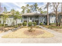Two-story condo featuring a charming facade, well-maintained landscaping and inviting outdoor spaces at 1221 Tidewater Dr. # 1922, North Myrtle Beach, SC 29582