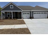 Charming single-Gathering home with two-car garage, covered porch, and well-manicured lawn at 242 River Edge Dr., Myrtle Beach, SC 29588