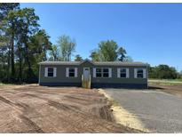 Charming single-story home featuring a clean design, complementary windows, and a well-manicured lawn at 2711 W Highway 9 Bypass, Loris, SC 29569