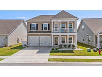 Charming two-story home boasts a welcoming front porch and a convenient two-car garage at 852 Harrison Mill St., Myrtle Beach, SC 29579