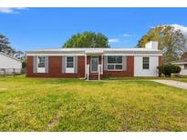 Charming single-story home with brick and vinyl siding, a metal roof, a well-maintained lawn, and gray shutters at 1287 Stalvey Ave., Myrtle Beach, SC 29577