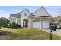 Charming brick home with a two-car garage and well-maintained lawn at 1312 Ashboro Ct., Myrtle Beach, SC 29579