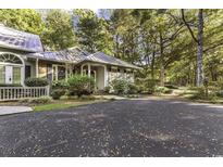 Charming single-story home featuring a spacious driveway and lush, mature landscaping at 145 Golden Bear Dr. # B4, Pawleys Island, SC 29585