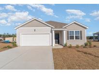 Charming single-story home featuring a two-car garage, manicured lawn, and neutral-toned siding at 2820 Riverboat Way, Conway, SC 29526