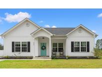 Charming single-story home features a bright blue front door and a well-manicured lawn at 2827 Allen Dew Rd., Conway, SC 29527
