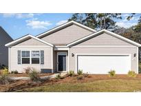 Charming single-story home with a well-manicured lawn and attached two-car garage at 327 Glade Ct., Loris, SC 29569