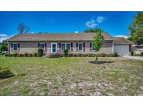 Charming single-story home with horizontal siding, brick-lined steps, manicured lawn and mature trees at 3341 Barnfield Rd., Conway, SC 29526