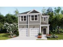 Charming new construction with two car garage, manicured flower beds and verdant trees at 417 Falling Leaf Loop, Myrtle Beach, SC 29588