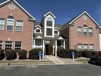 Charming brick building exterior with accessible entrance and manicured landscaping at 4370 Crepe Myrtle Ct. # F, Murrells Inlet, SC 29576