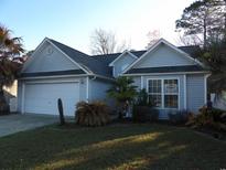 Charming single-story home with manicured lawn, mature trees, and a two-car garage at 4664 Southgate Pkwy., Myrtle Beach, SC 29579
