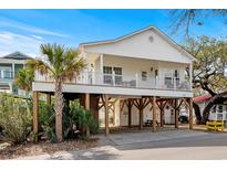 Charming elevated home with a spacious porch and ample covered parking area at 6001- L08 S Kings Hwy., Myrtle Beach, SC 29575