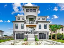 Stunning three-story home with a modern farmhouse design and elegant stone accents at 804 Waterton Ave., Myrtle Beach, SC 29579