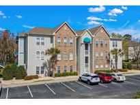 A charming condo with a combination of vinyl siding and stone facade with well-kept landscaping at 9730 Leyland Dr. # 1, Myrtle Beach, SC 29572
