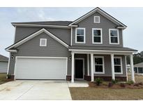 Charming two-story home with a two-car garage and inviting front porch at 1304 Winding Creek Way, Myrtle Beach, SC 29588