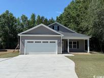 New construction home showing the front of the house with driveway and two car garage at 1397 Knotty Branch Rd., Conway, SC 29527