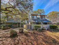 Inviting townhome featuring unique architecture, complemented by lush landscaping, mature trees, and unit number sign at 400 Melrose Pl. # 14-A, Myrtle Beach, SC 29572