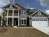 Charming two-story home featuring a two-car garage and a welcoming covered porch at 515 Oak Landing Dr., Myrtle Beach, SC 29588