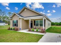Charming one-story home with tan siding, black shutters, green lawn, and a cozy front porch at 1390 Highway 129, Galivants Ferry, SC 29544