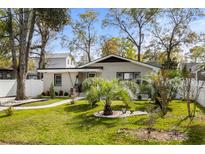 Charming one-story home with a landscaped yard, featuring a brick facade and mature trees at 613 Cypress Dr., Surfside Beach, SC 29575