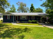 Charming single-story home with a well-maintained lawn, carport, and a welcoming front entrance at 710 62Nd Ave. N, Myrtle Beach, SC 29572