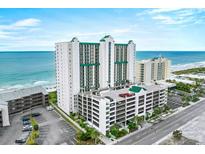 Expansive aerial view of oceanfront condo building with parking garage and stunning ocean views at 102 N Ocean Blvd. # 903, North Myrtle Beach, SC 29582
