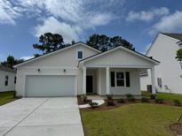 Charming one-story home with a well-manicured lawn, garage, and inviting entrance at 1031 Laconic Dr., Myrtle Beach, SC 29588