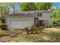Charming two-story home featuring a two-car garage and a cozy front porch at 1213 Oak St., Conway, SC 29526