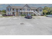 Apartment complex exterior featuring multiple units, parking, and well-maintained landscaping at 221 Port Smith Dr. # 6, Myrtle Beach, SC 29588