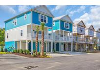 Stunning two-story beach home featuring blue and white exterior and coastal charm at 2309 Seaseeker Ln., Myrtle Beach, SC 29577