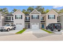 Charming townhomes with unique exteriors, driveways, and attached one-car garages at 247 Christiana Ln. # D, Myrtle Beach, SC 29579