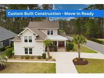 Two-story home with manicured lawn and mature landscaping, showcasing its inviting curb appeal at 2935 Moss Bridge Ln., Myrtle Beach, SC 29579