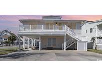 Charming two-story home with a balcony and staircase leading to the first level at 301 58Th Ave. N, North Myrtle Beach, SC 29582