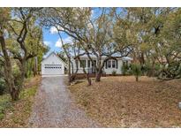 Charming home featuring a detached garage and mature trees at 313 73Rd Ave. N, Myrtle Beach, SC 29572