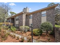 Charming brick and siding condo with well-maintained landscaping and mature trees at 404 75Th Ave. N # E, Myrtle Beach, SC 29572