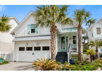 Charming home featuring a two-car garage, well-kept landscaping, and a quaint front porch at 5361 Ocean Village Dr., Myrtle Beach, SC 29577