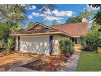 Charming single-story home featuring an attached garage, well-maintained landscaping, and a welcoming entrance at 5525 Springs Ave., Myrtle Beach, SC 29577