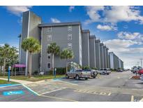 Low-angle exterior shows multiple-story building with parking and some tropical plants at 5905 S Kings Hwy. # A551, Myrtle Beach, SC 29575