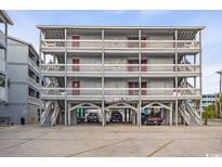 Three-story condo building featuring multiple units, elevated design, and parking underneath at 625 N Waccamaw Dr. # 301, Murrells Inlet, SC 29576