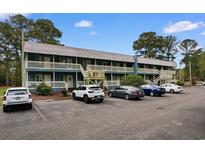 Charming two-story condo building with lots of parking and a stairway to the balcony at 610 Putters Ln. # H-109, Little River, SC 29566