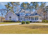 Charming home featuring manicured landscaping and a welcoming wrap-around porch at 901 Bear Lake Dr., Longs, SC 29568
