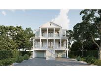 Stately three-story home with multiple balconies, grand columns, and a two-car garage at 914 Perrin Dr., North Myrtle Beach, SC 29582