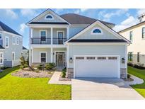 Two-story home featuring a two-car garage, covered porch, black trim and a manicured lawn at 186 Palmetto Harbour Dr., North Myrtle Beach, SC 29582