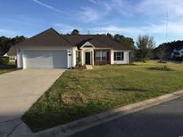 Charming single-story home with a well-manicured lawn and an attached two-car garage at 232 Marbella Dr., Murrells Inlet, SC 29576