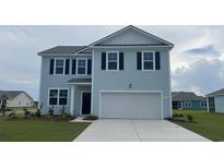 Charming two-story home with light blue siding, black shutters, and a two-car garage at 5159 Yellowstone Dr., Conway, SC 29526