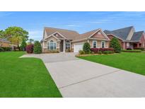 Charming single-story home featuring a well-manicured lawn and a long driveway at 826 Sand Binder Dr., Myrtle Beach, SC 29579
