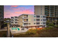 Beautiful exterior of the building with a pool and balcony views at 1011 South Ocean Blvd. # 201, North Myrtle Beach, SC 29582