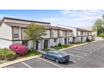 Townhomes with landscaping in a parking lot showcase charming architectural details, with parking available directly in front at 1012 Possum Trot Rd. # C21, North Myrtle Beach, SC 29582
